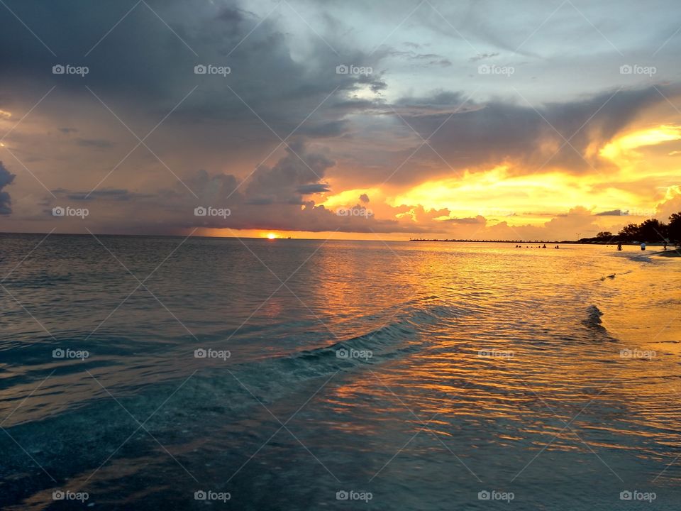 Sunset behind clouds.