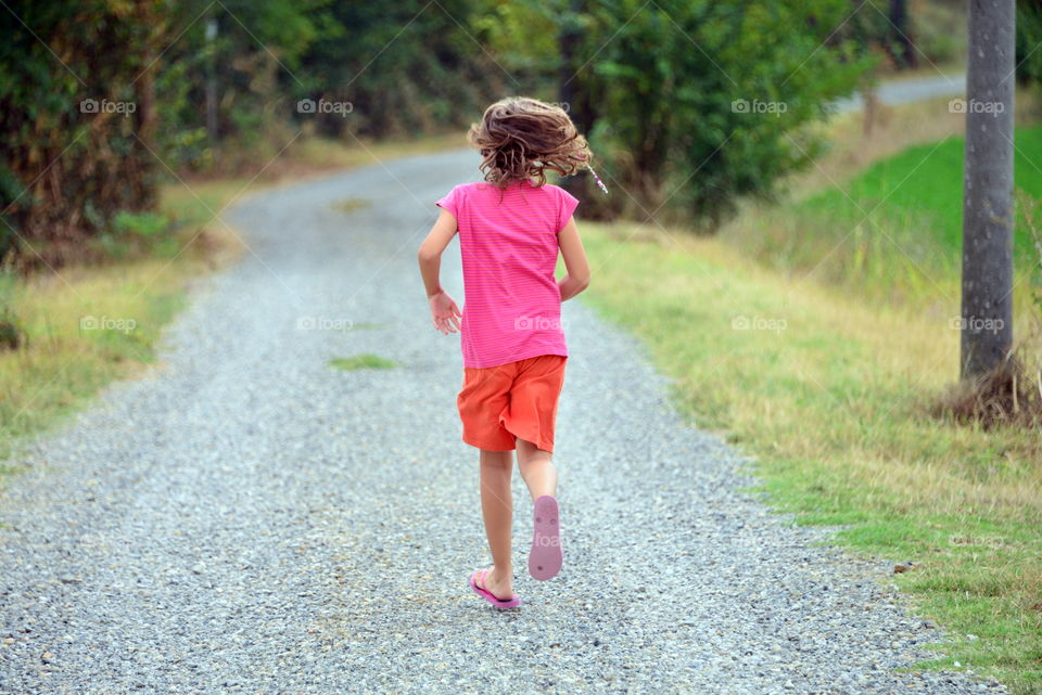 a little girl running in the park