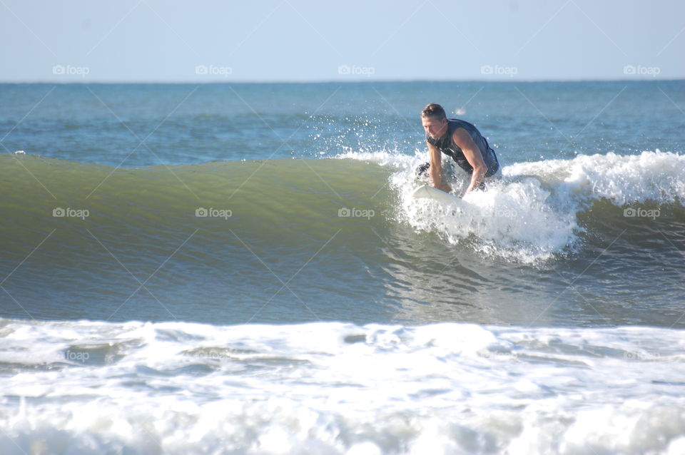 Trying to get up on his board