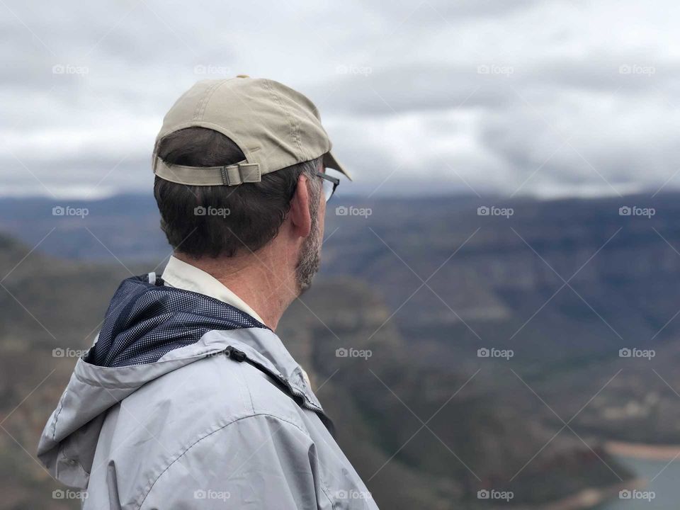 Man looking out over canyon