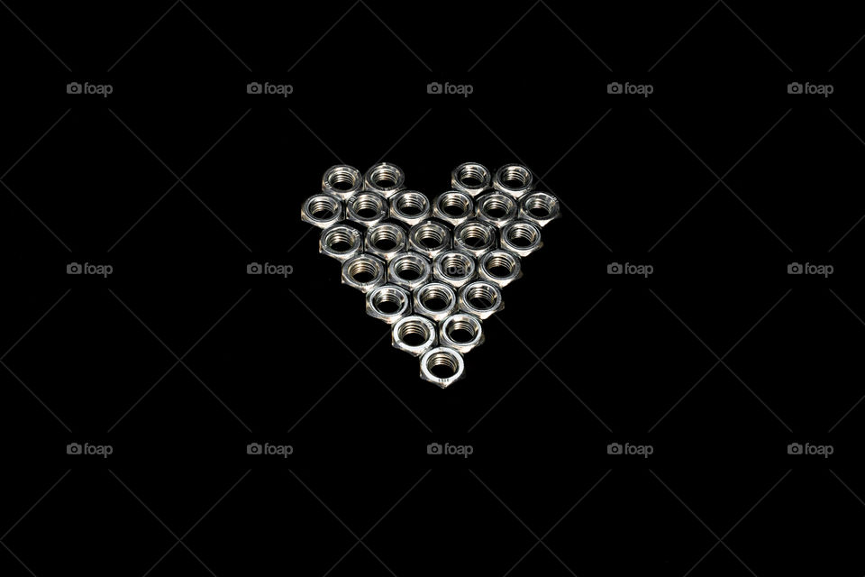 Hex bolts in hearth shape. Creative love concept