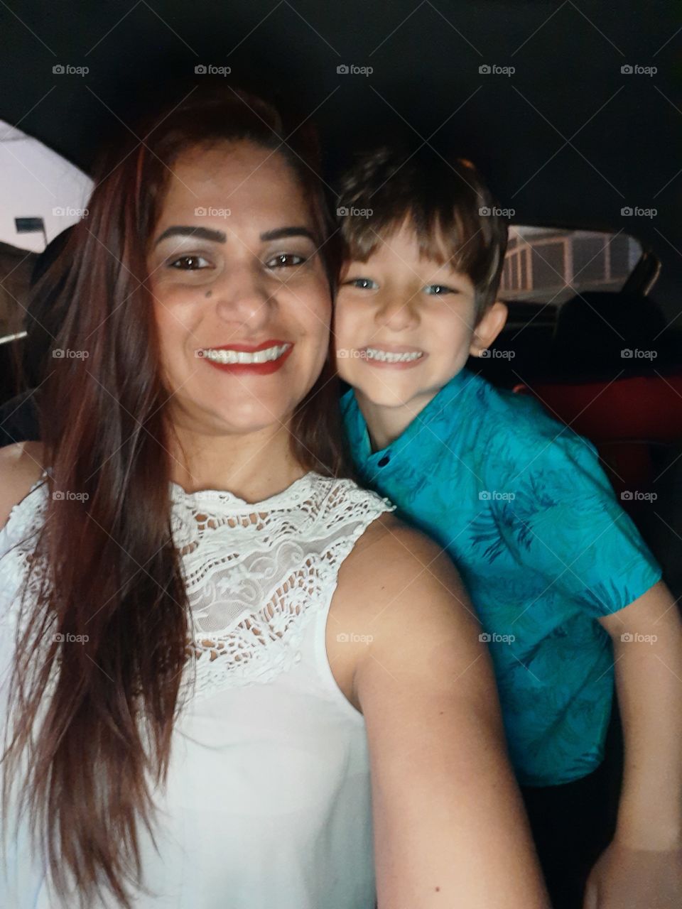 mother and son smiling in the car