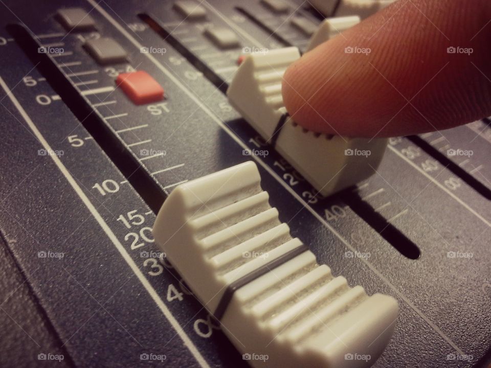 Hands on dj master mixer. Hand on a mixer.