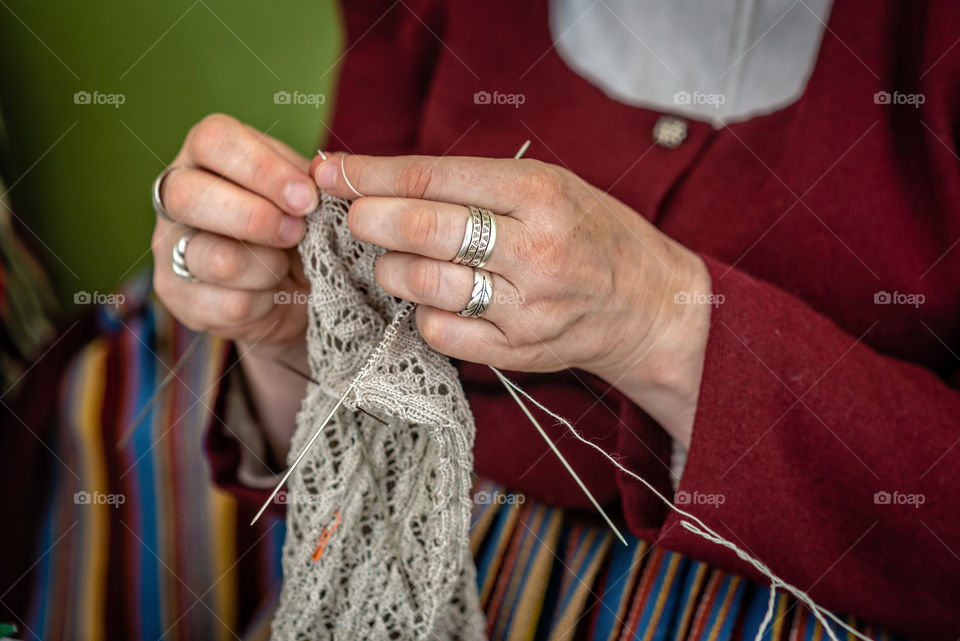 close-up of the hands of an elderly woman knitting