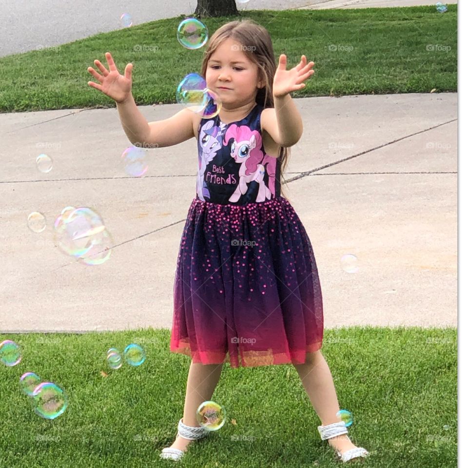 Having Lots Of Fun Catching Bubbles in Summertime
