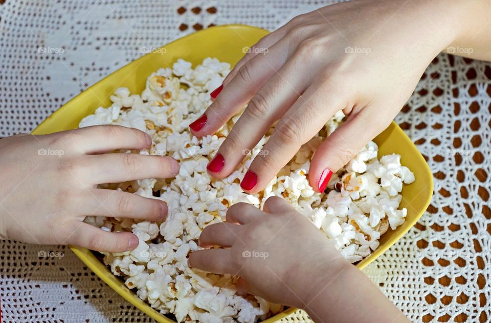 Hands and popcorn