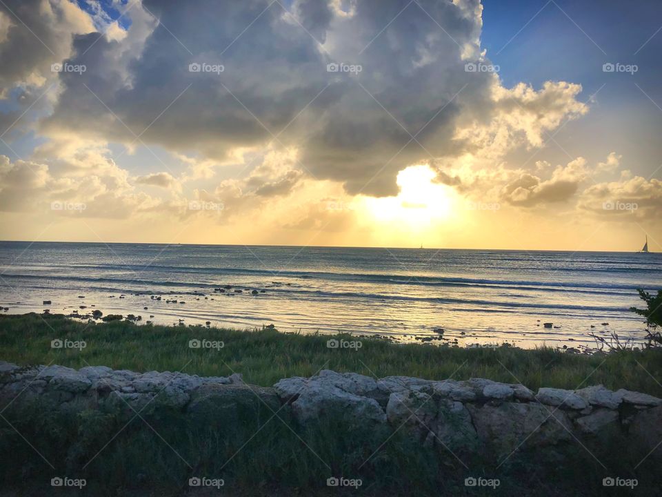 Sunset behind the clouds over the ocean in Aruba during our UTV excursion with Carnival Sunshine Cruise 2018