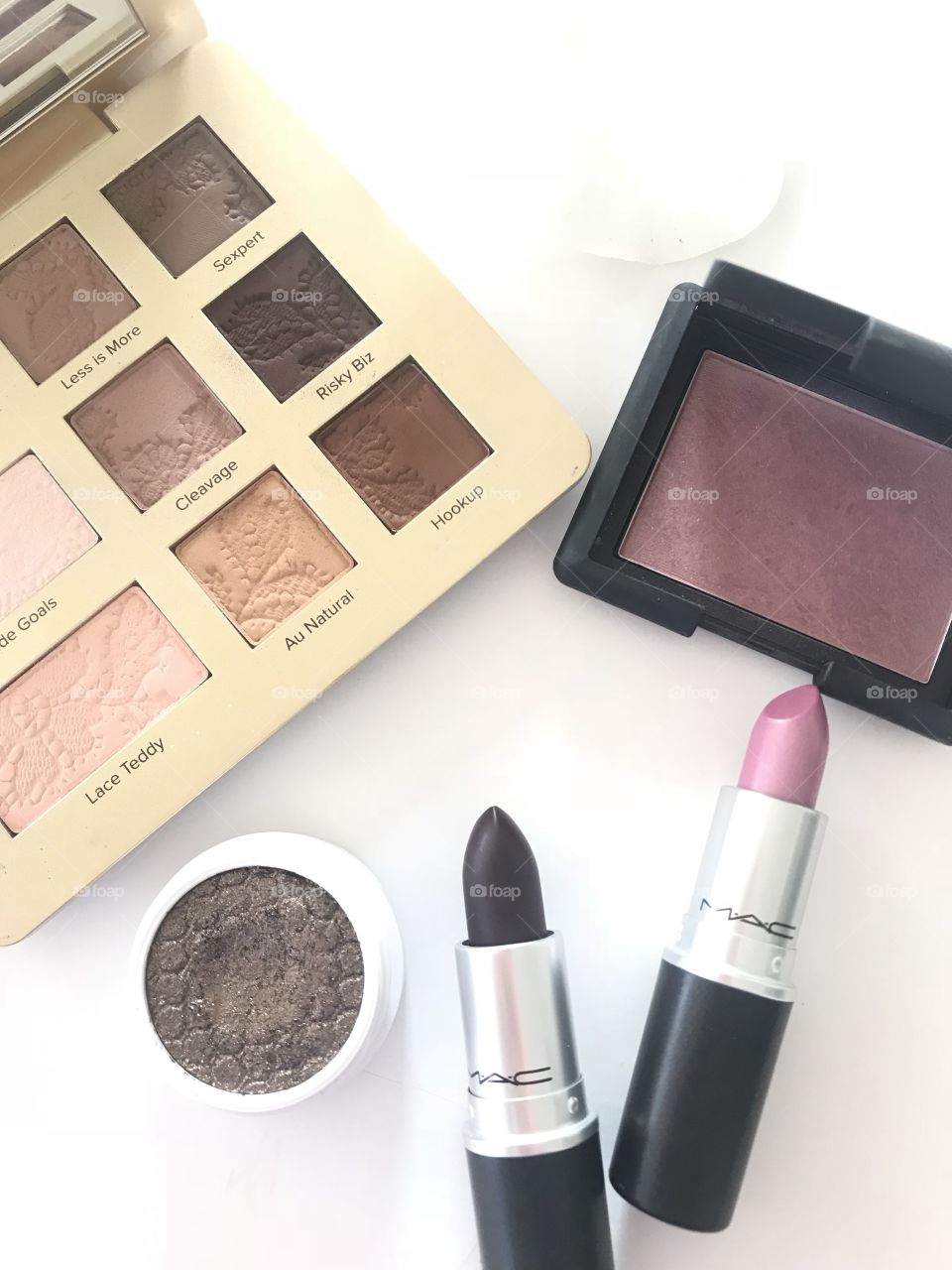 Makeup flat-lay with eyeshadow palette and blush. 
