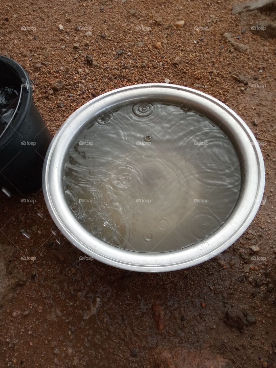 rain water dropping inside the basin and forming waves.
