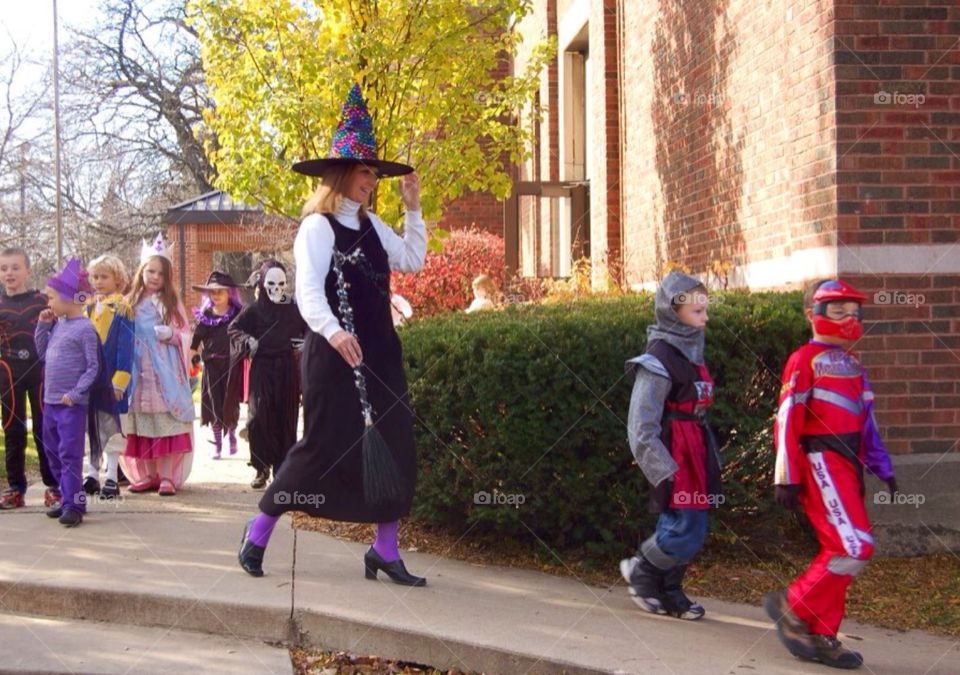 Halloween parade. School children celebrating Halloween , with a parade outside the school.