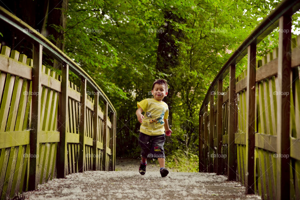 Boy running on the bridge. Thithi enjoy spring