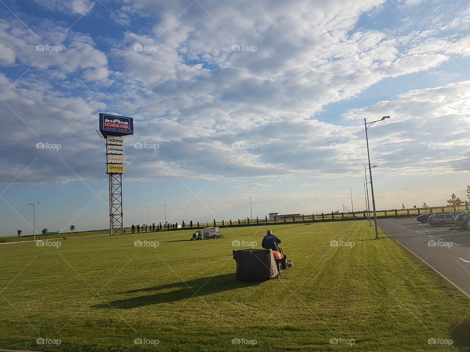 man  mowing grass with  lawnmower