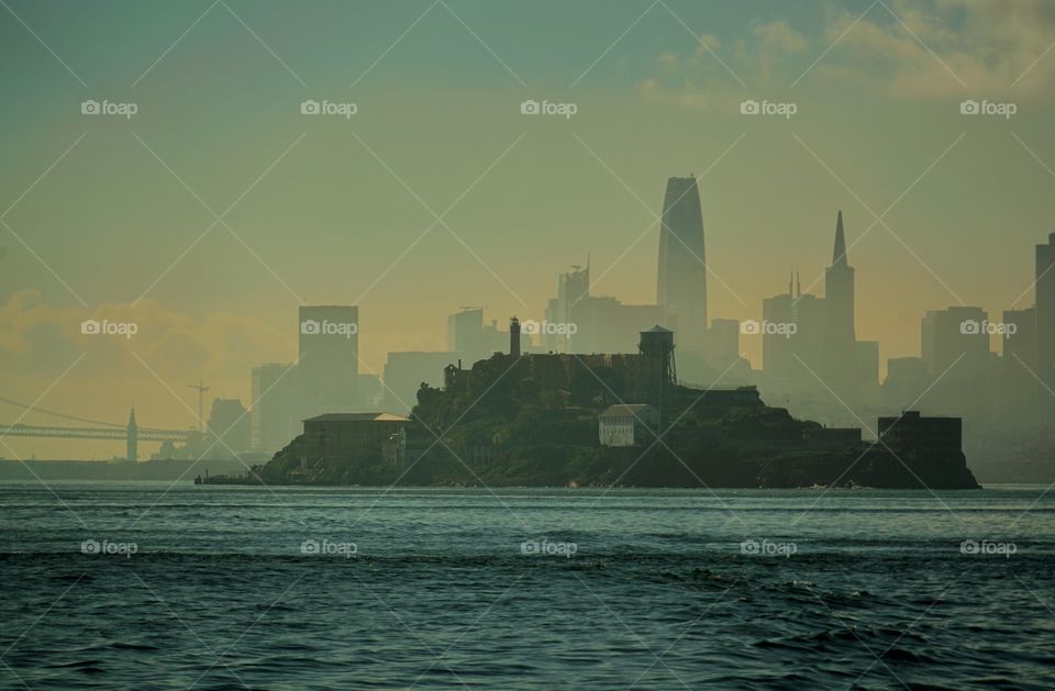 Alcatraz Prison With San Francisco City Skyline In The Morning