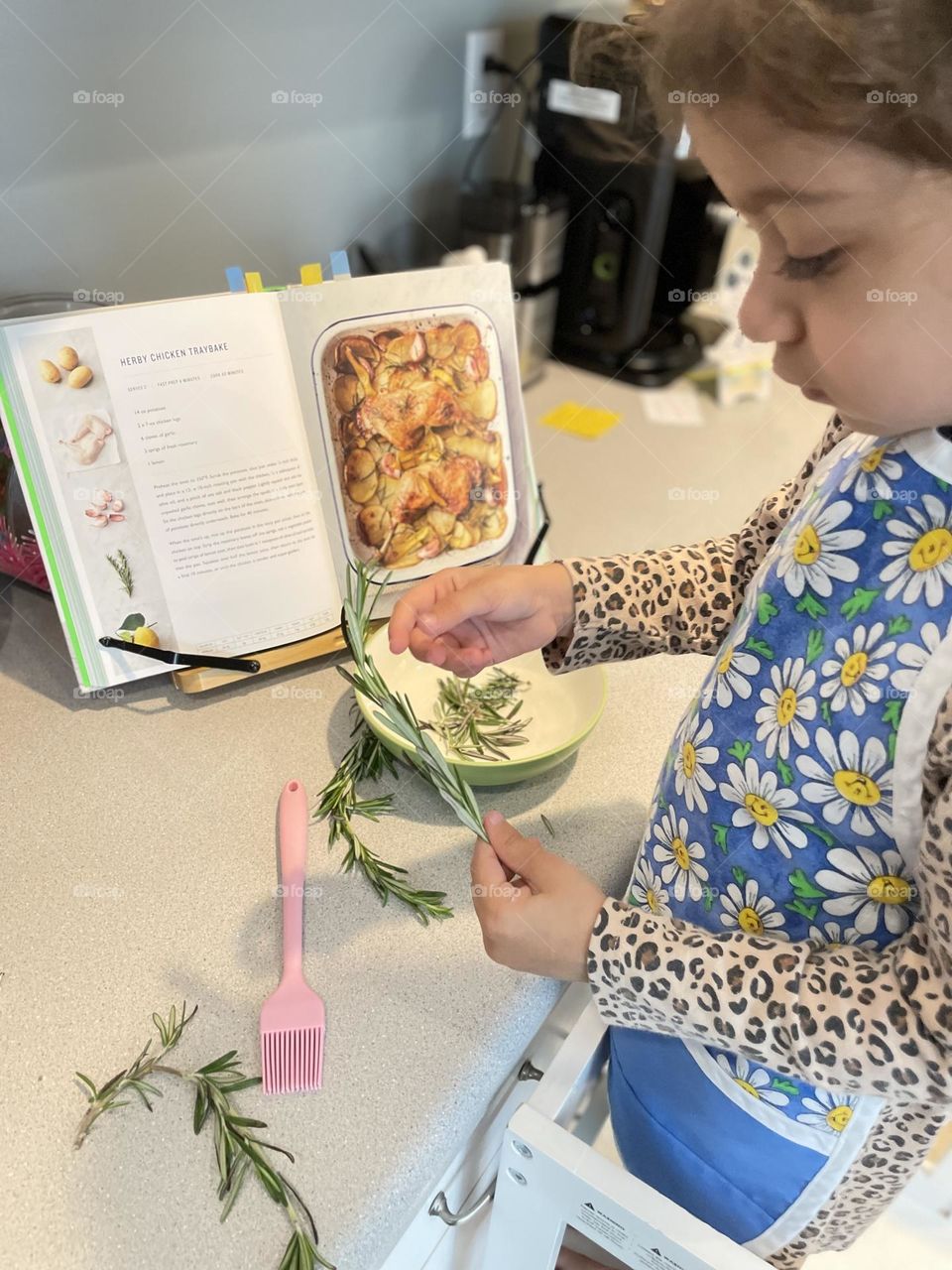 Cooking with toddlers, toddler removes rosemary from stem, toddler helps mommy make dinner, making dinner with mommy, preparing a chicken dinner 