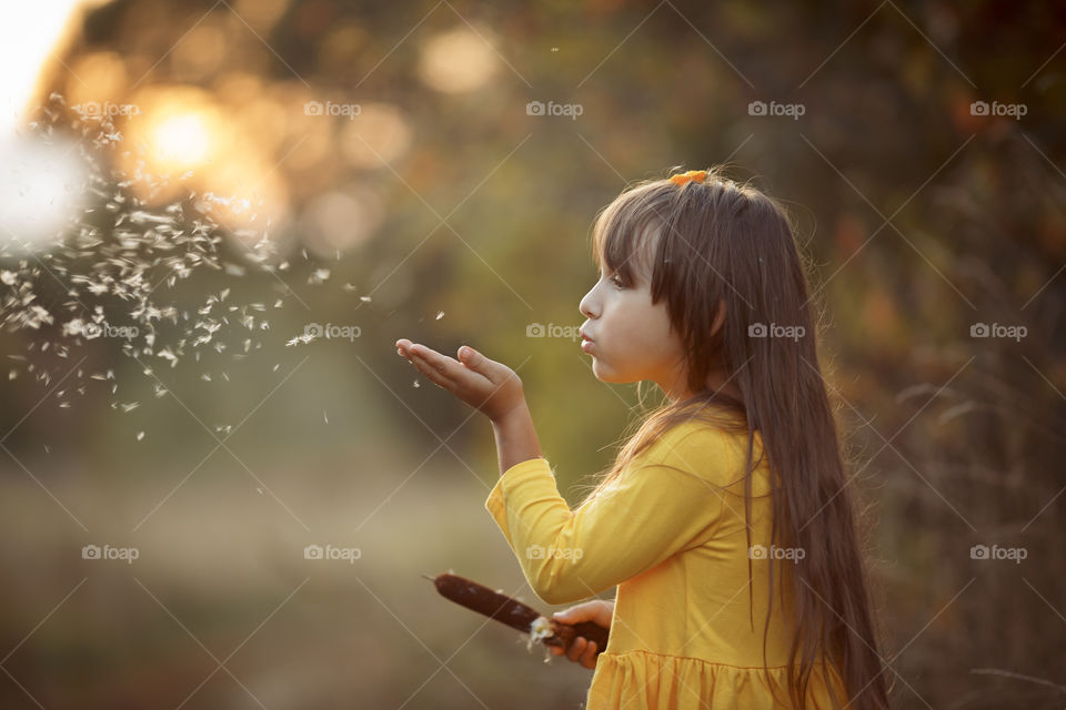 Little girl in yellow dress outdoor portrait 