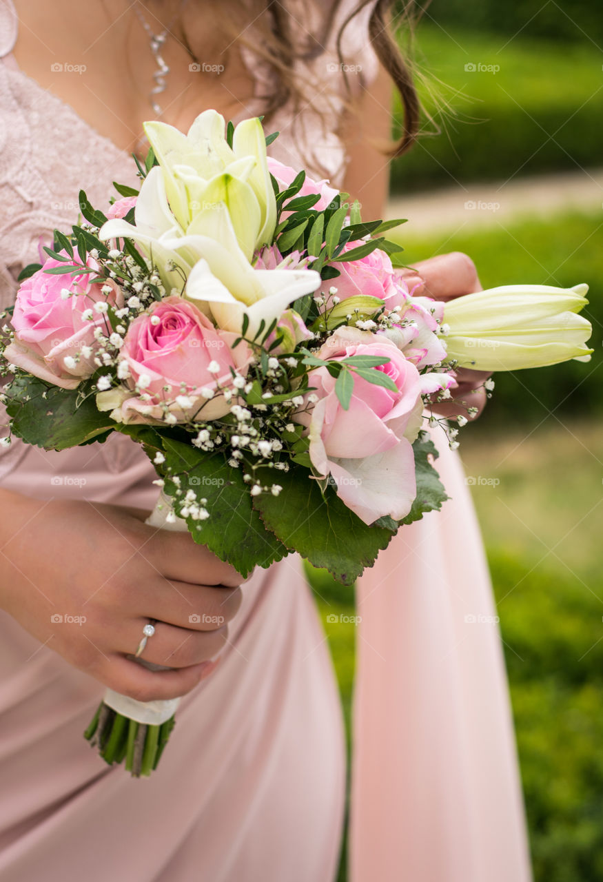 hand holding wedding bouquet