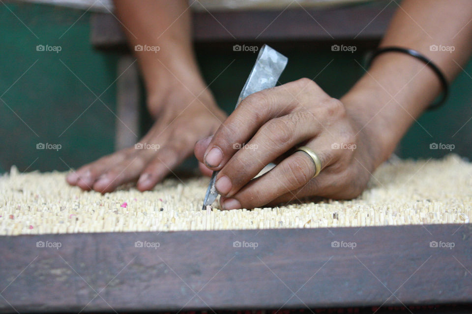 Close-up of a man making matchsticks