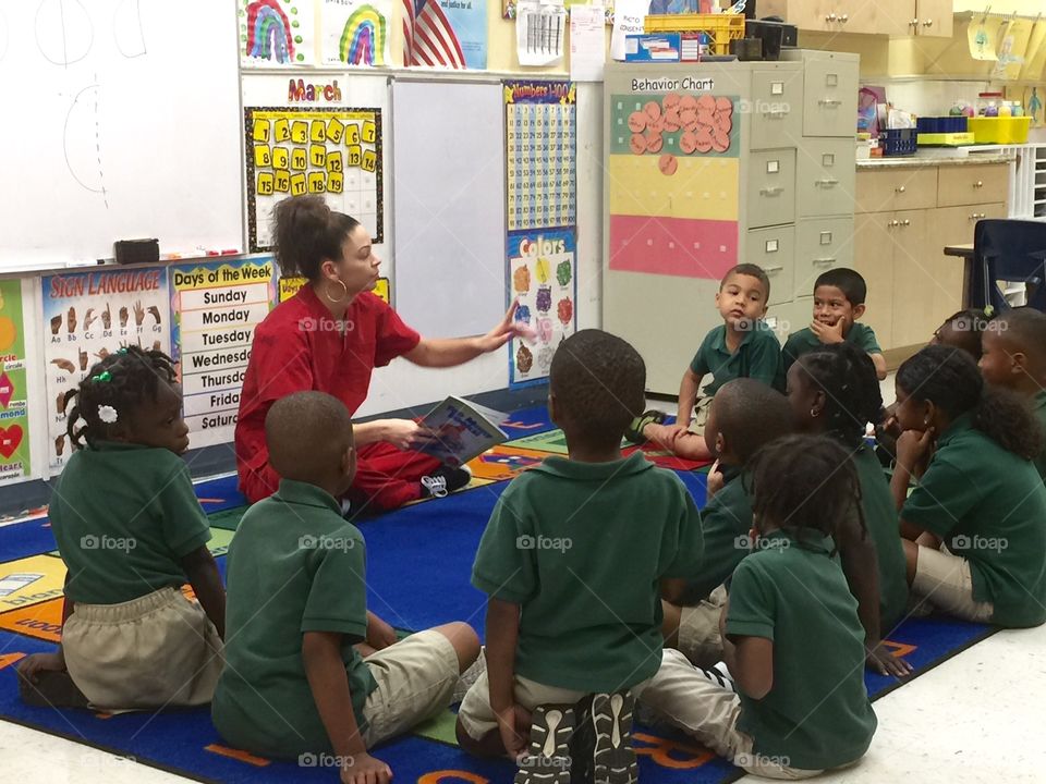 School. Teacher with preschool kids in classroom