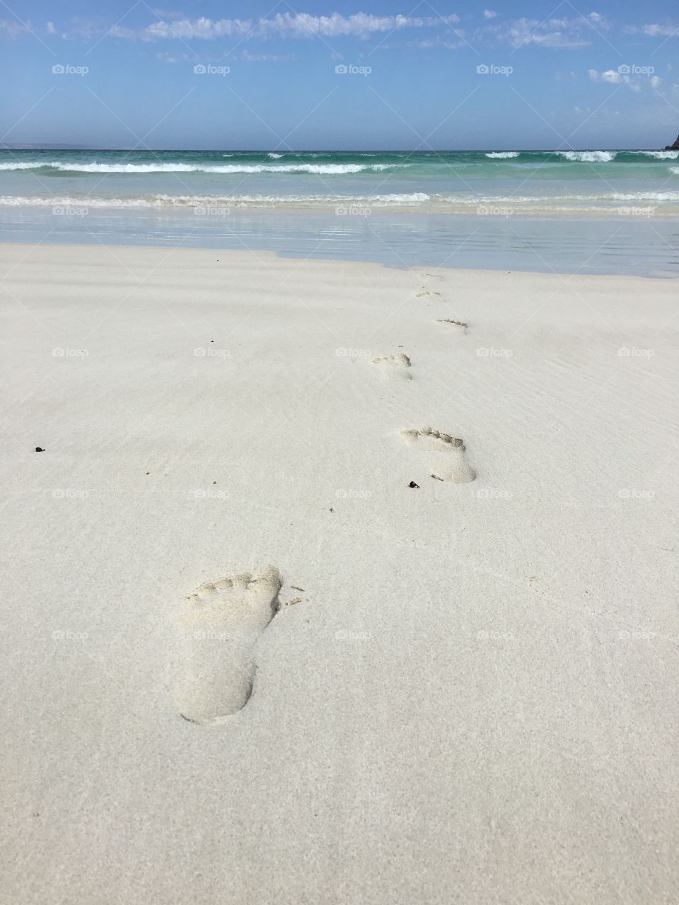 Footprints in the sand on an untouched pristine remote secluded white sand beach in south Australia, 