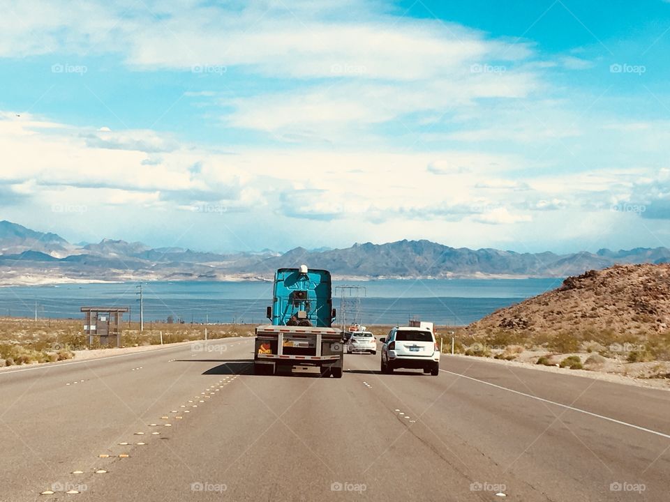 Trucks, road, and sky