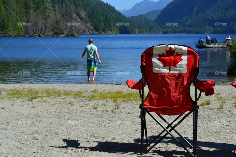 Canadian flag on camping chair at lake