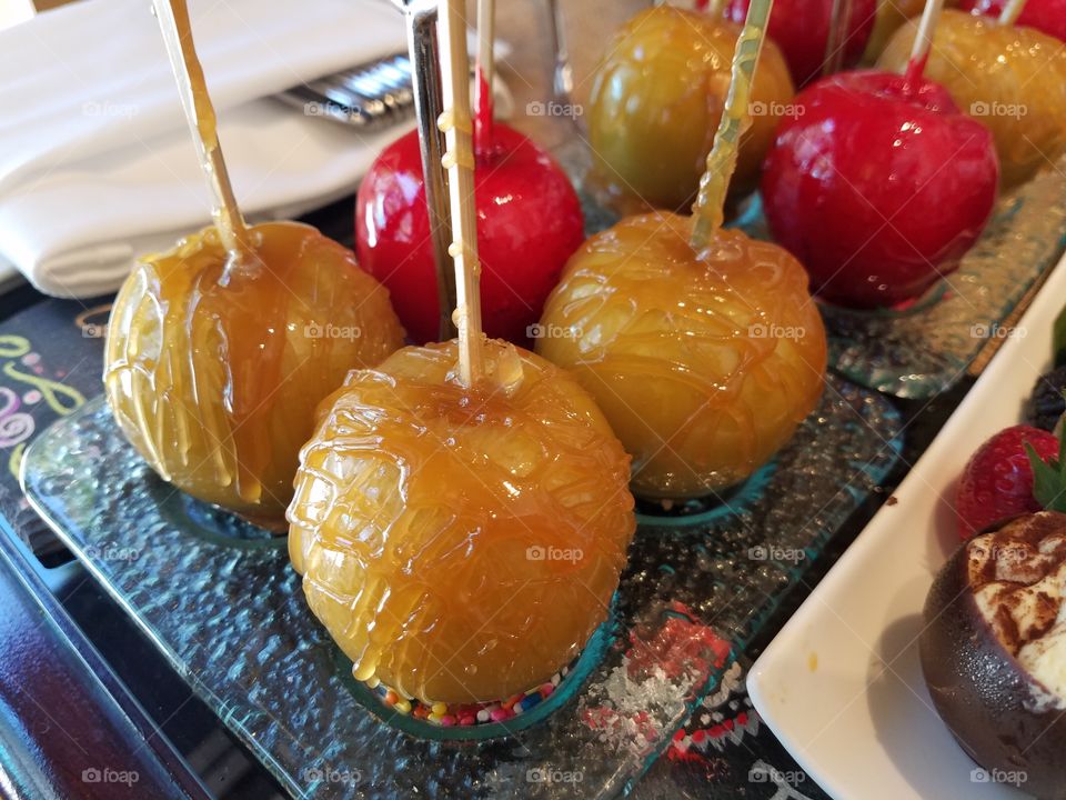 caramel apples with shiny sugar coating