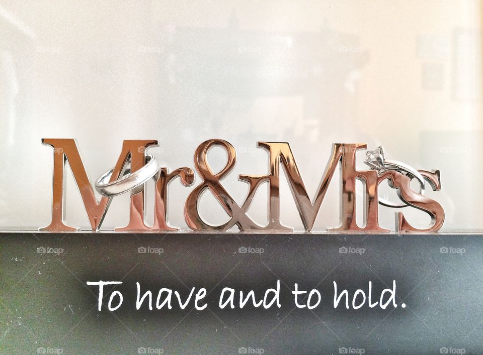 Close-up of diamond rings with mr and mrs text