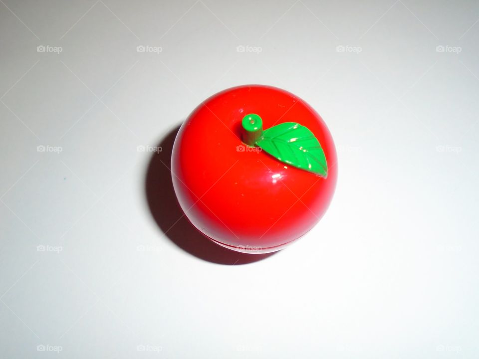 Lip balm in apple-shaped container