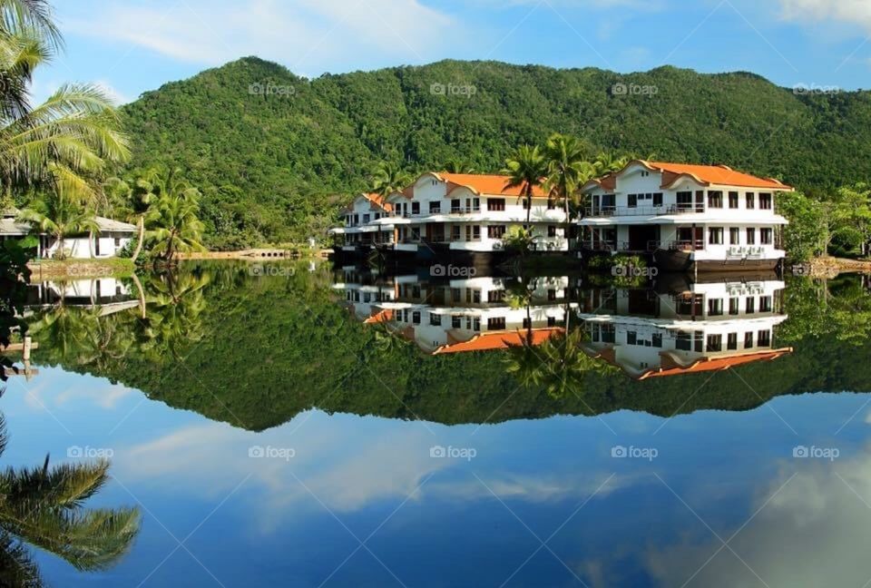 houses on the lake reflected in it Thailand 