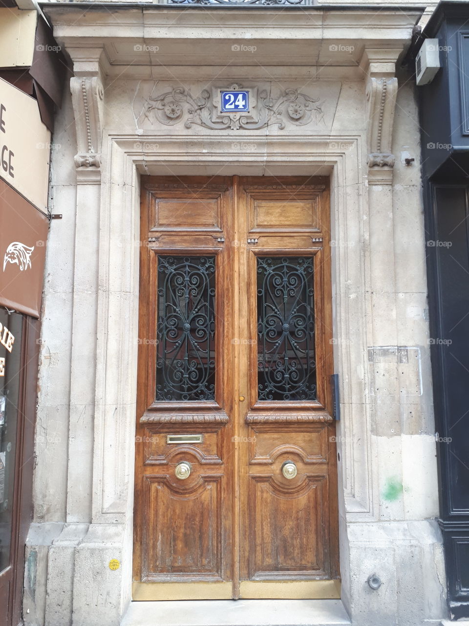 Wooden brown antique entrance door with metal grate