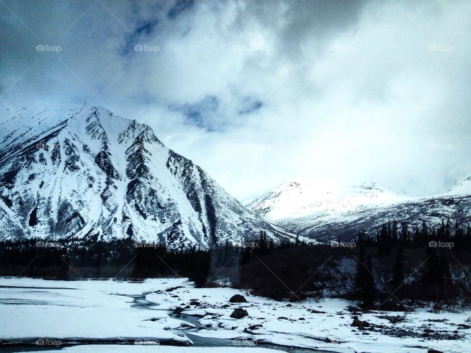 Scenic view of mountain against cloudy sky