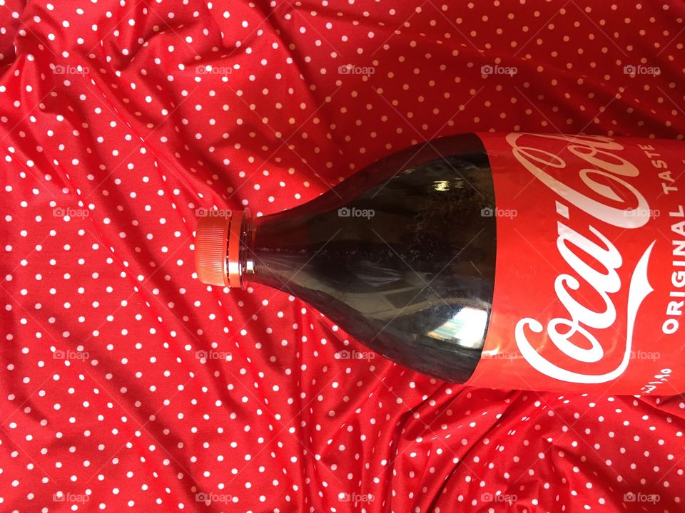 Coca cola bottle on red background