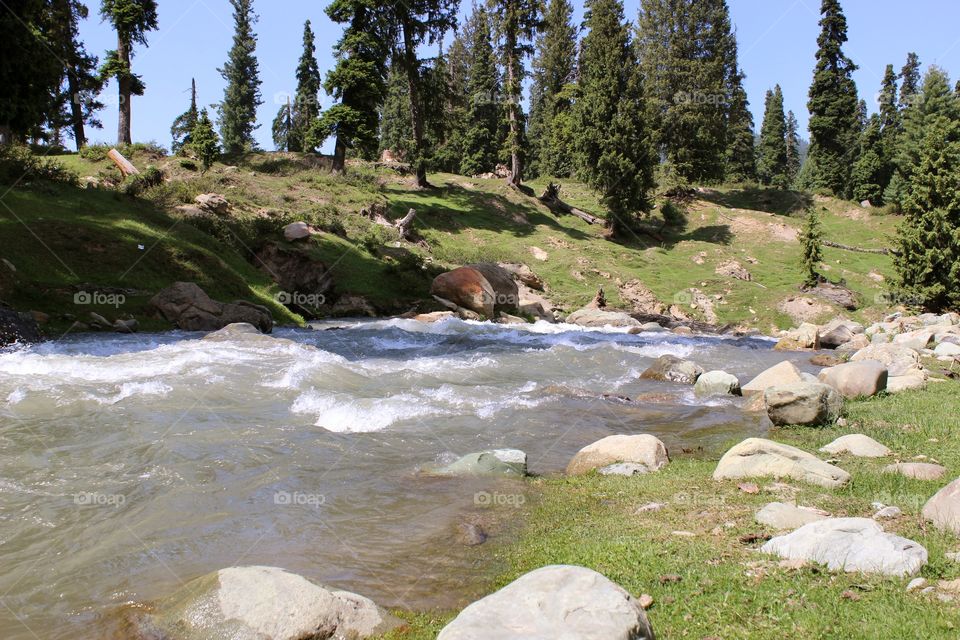 a river flowing through the himalayan mountain range