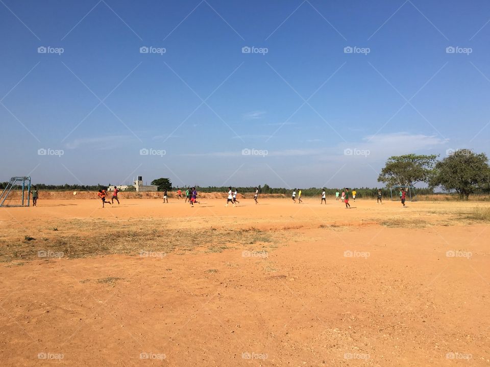 Bengaluru, India. School children playing soccer.
