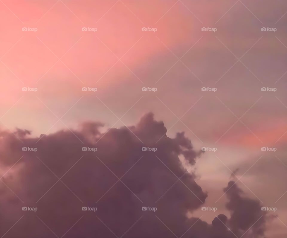 A cloudscape in the night with a peach sky