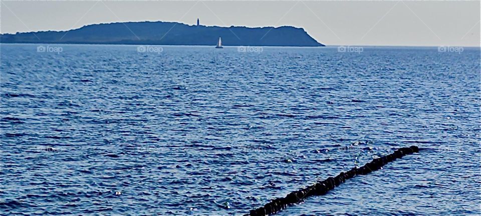 Across the “Baltic Sea” at the “Strelasund” in “Mecklenburg - Western Pomerania”, Germany we see the island “Hiddensee” from the island of “Rügen”. “Hiddensee” has been a home to famous artists in the early 20th century. 2024. Hypnotic Productions