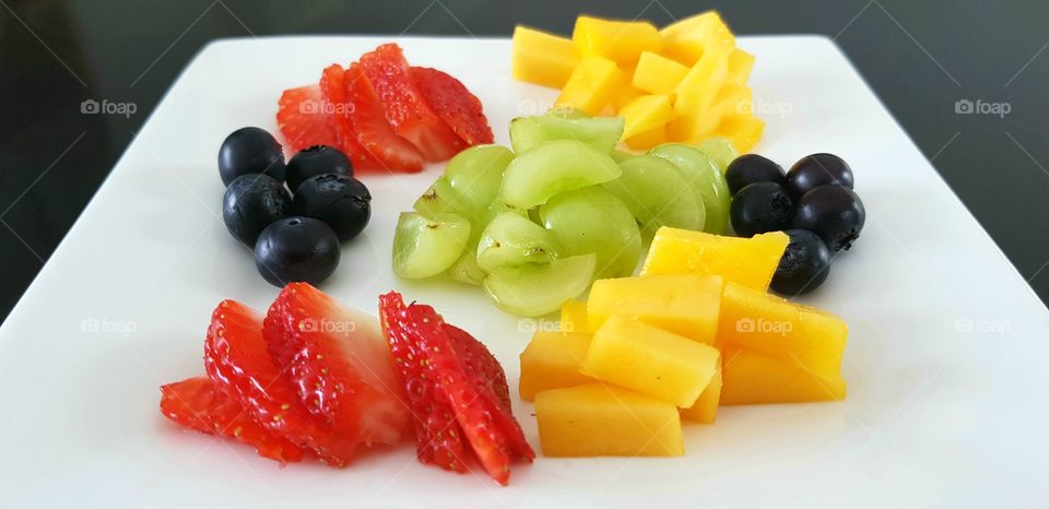 Healthy eating, fruity platter - grapes, blueberries,  mango and strawberries