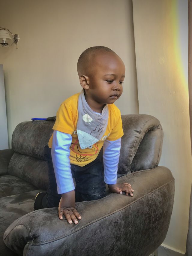 childhood child real people indoors one person sofa men casual clothing furniture boys front view home interior