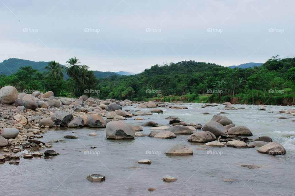 This panorama shows how harmoniously the stones and water are on the outskirts of a large river, this is because the river is receding and the expanse of rock on the edge of the river is very clear.
