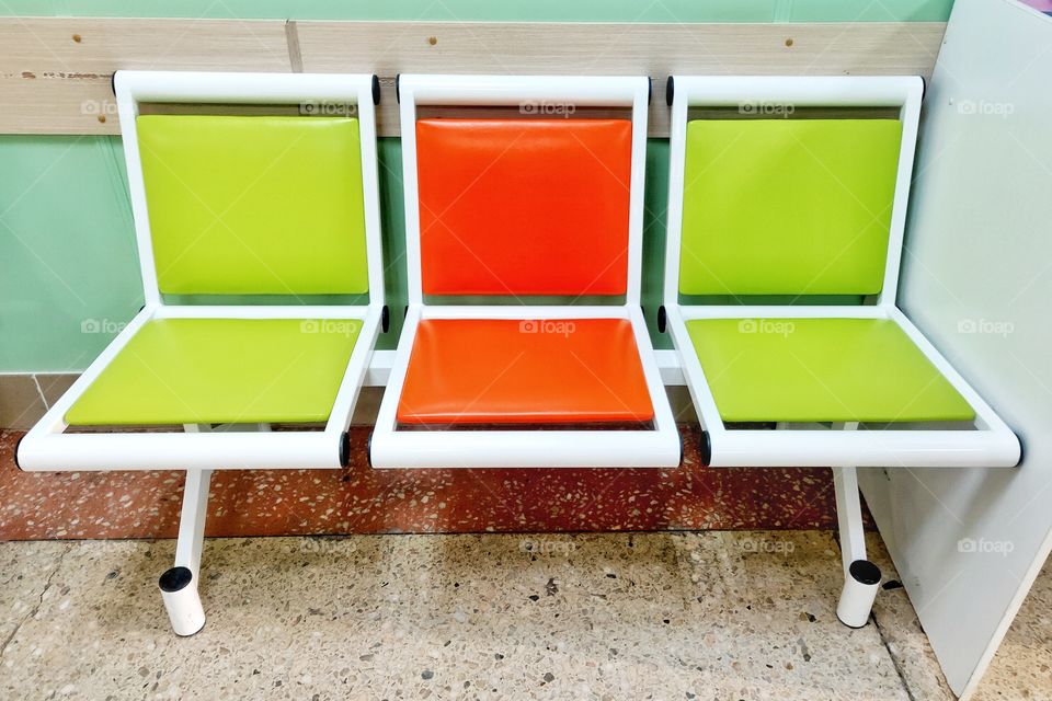 three brightly colored chairs