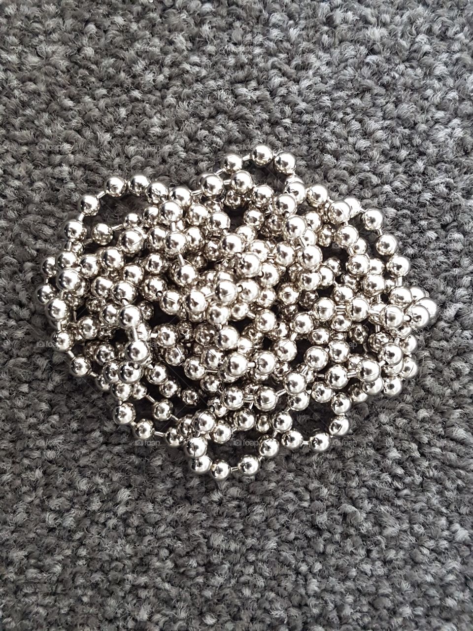 Beads on top of carpet.
