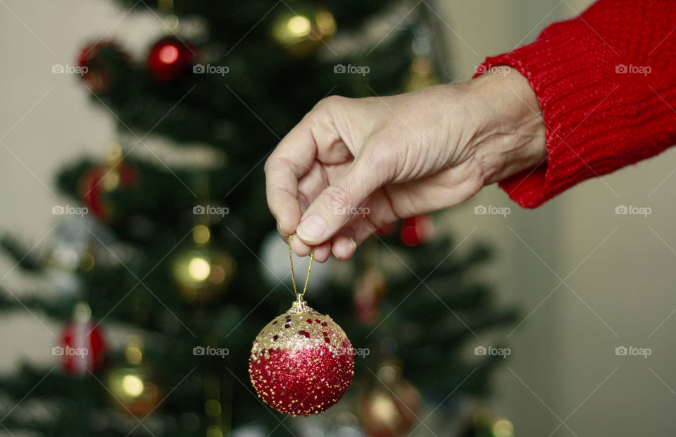 Holding Christmas red ball