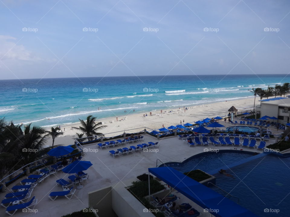 Hotel balcony view of grounds and beach, Cancun Mexico