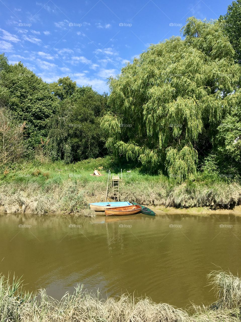 Wooden boat on shore of river ouse, South Downs National Park, Lewes, East Sussex, England