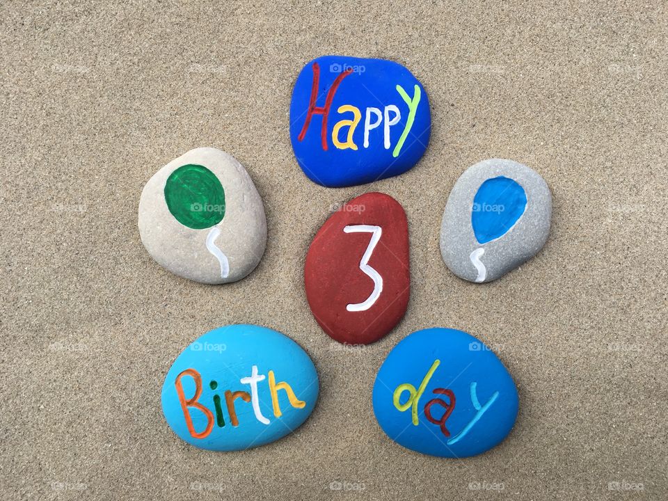 Happy 3 Birthday on colored stones 