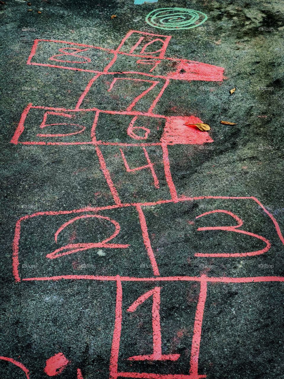 Hopscotch drawn by 10 year old girl while playing outdoors 