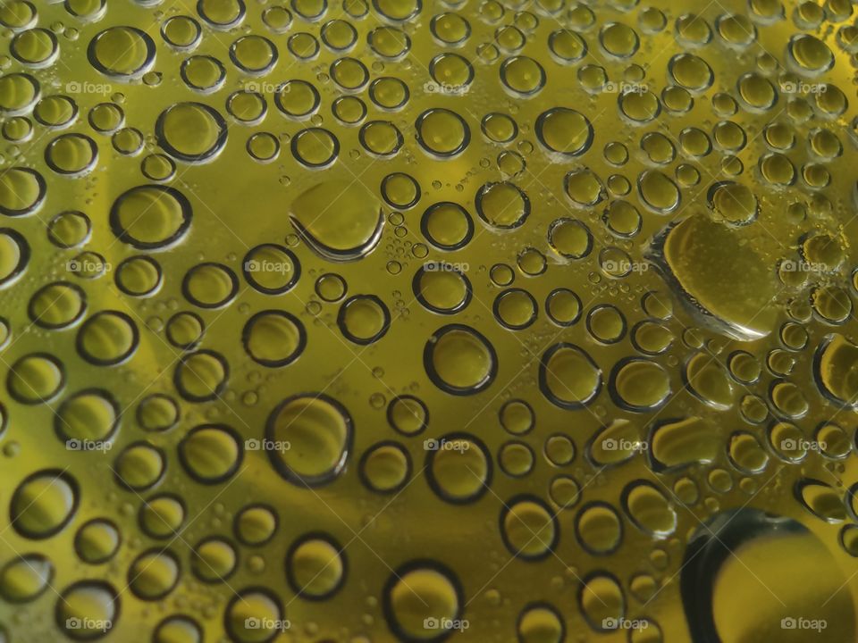 Condensate on a transparent surface on a yellow background