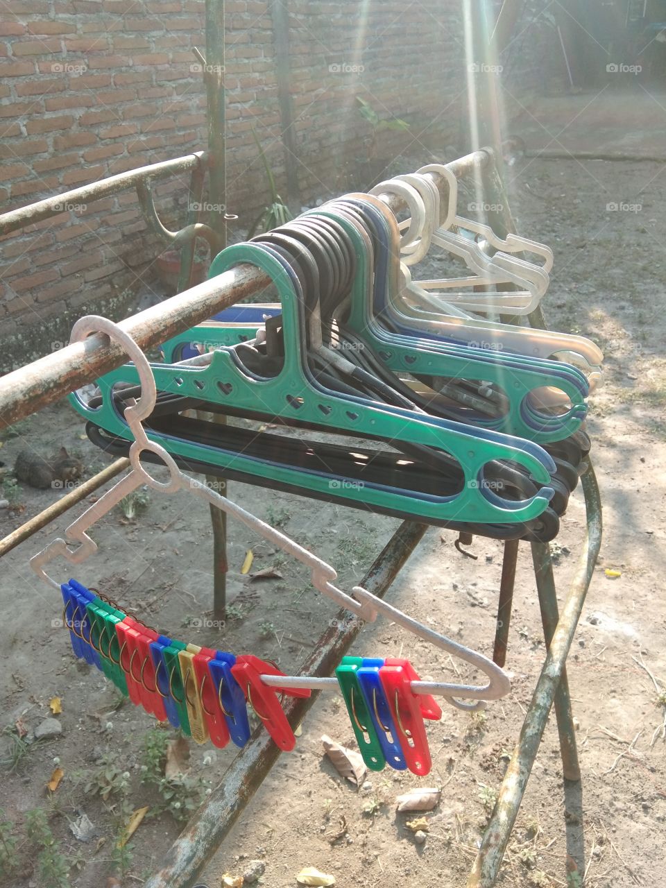 clothes hangers lined up in clotheslines