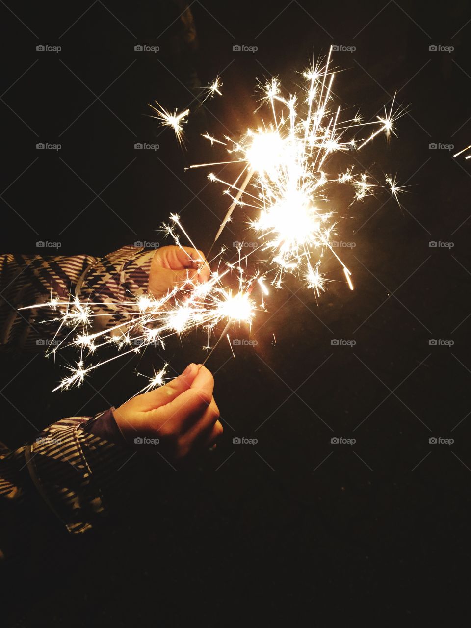 Hands holding sparkler