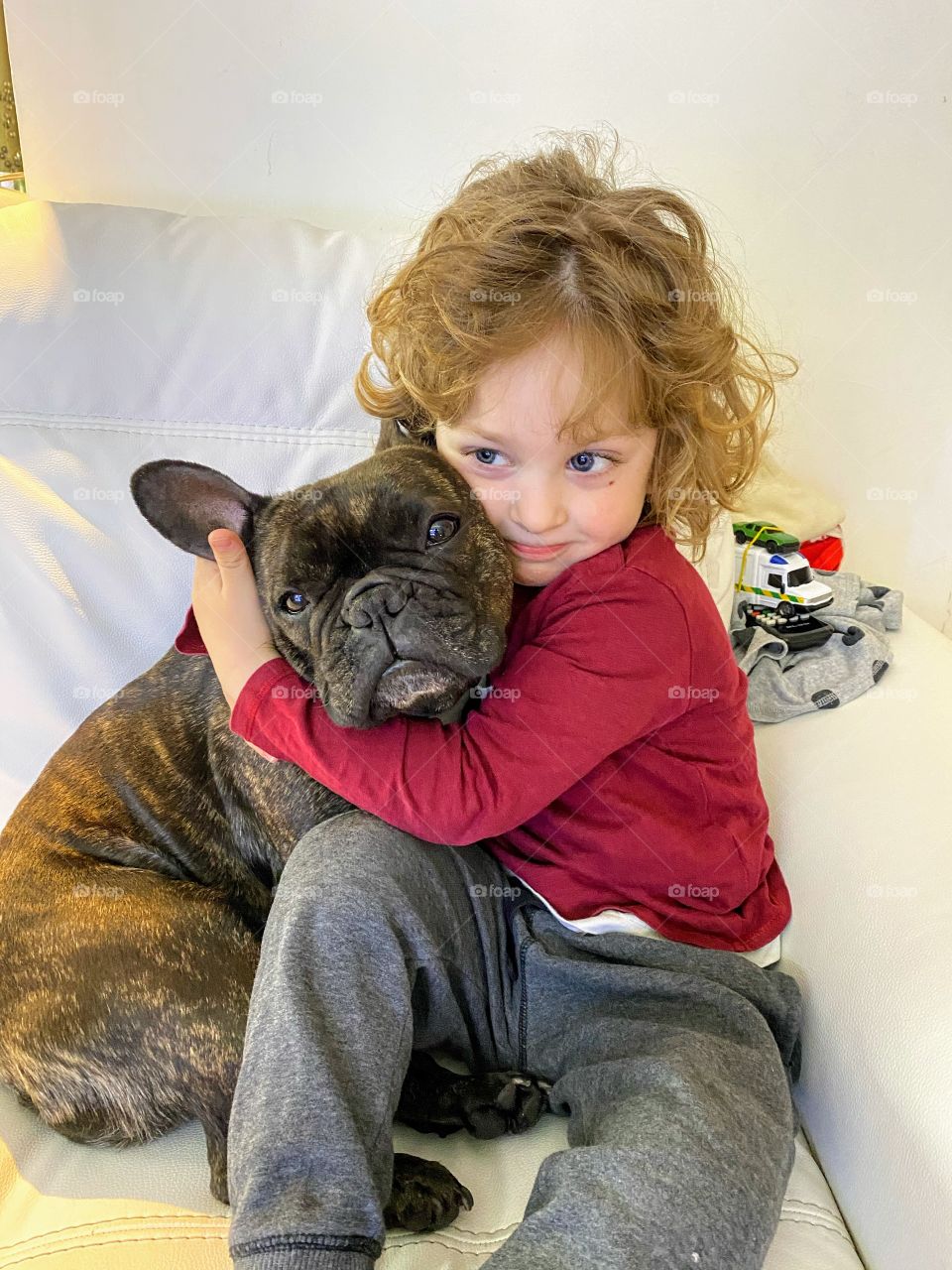 Little boy hugging a dog 